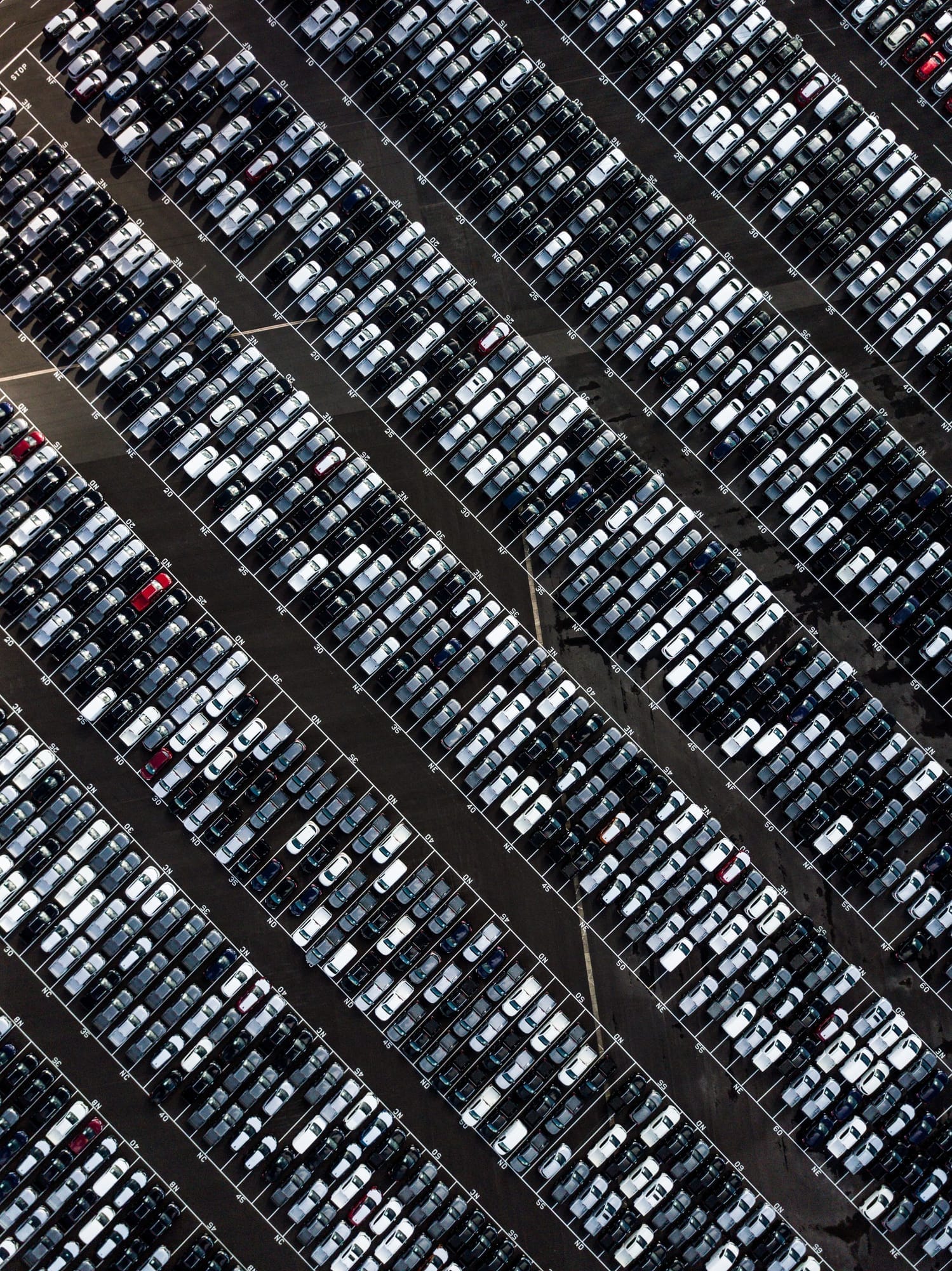 Aerial view of thousands of vehicles parked in dense rows